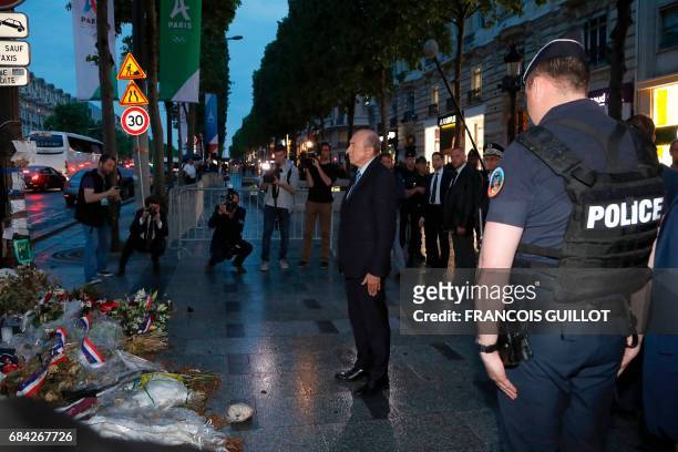 Newly appointed French Interior Minister Gerard Collomb pays his respects at a makeshift memorial for French policeman Xavier Jugele, killed by a...