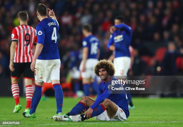 Marouane Fellaini of Manchester United goes down injured during the Premier League match between Southampton and Manchester United at St Mary's...