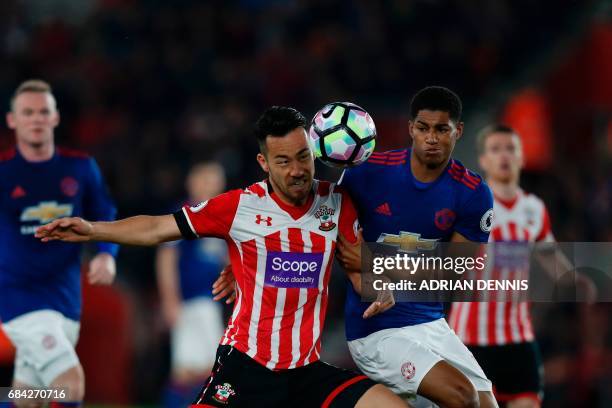 Manchester United's English striker Marcus Rashford battles with Southampton's Japanese defender Maya Yoshida during the English Premier League...