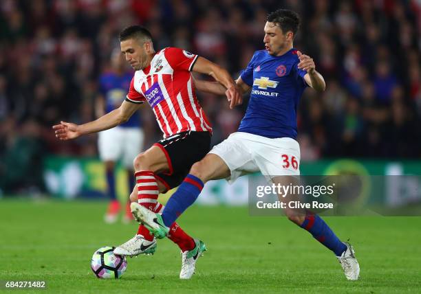 Dusan Tadic of Southampton and Matteo Darmian of Manchester United battle for possession during the Premier League match between Southampton and...