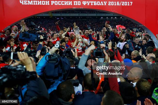 Players and supporters of FC Spartak Moscow celebrate with trophy after winning the Russian Premier League championship following the match between...