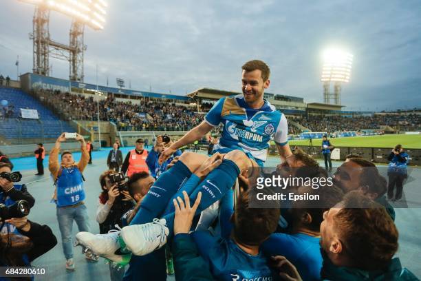 Nicolas Lombaerts of FC Zenit St. Petersburg is being lift up by his teammates as he waves goodbye to fans after the Russian Football League match...