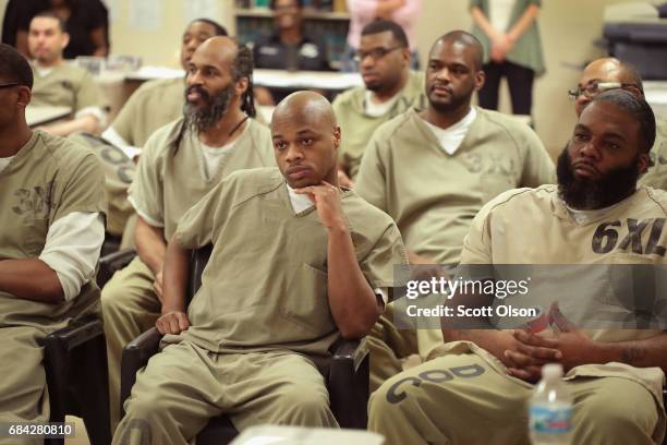 Inmates at the Cook County Jail watch as fellow inmates compete in a chess tournament online with inmates from the Prison Complex of Viana in...