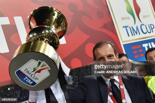Juventus' coach from Italy Massimiliano Allegri holds the trophy after winning the Italian Tim Cup final on May 17, 2017 at the Olympic stadium in...