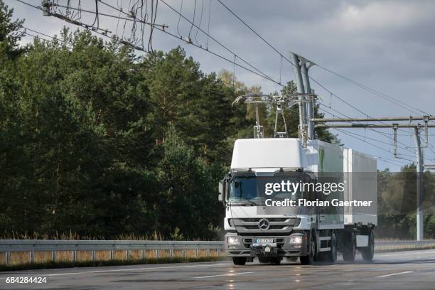 Truck, electrically powered by overhead lines, drives on a test track on April 11, 2017 in Gross Doelln, Germany.