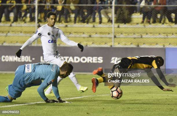 Pablo Escobar of Bolivia's The Strongest vies for the ball with Brazilian Santos goalkeeper Vanderlei during a Copa Libertadores football match at...
