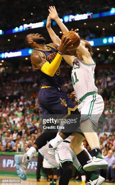 LeBron James of the Cleveland Cavaliers drives to the basket against Kelly Olynyk of the Boston Celtics in the first half during Game One of the 2017...