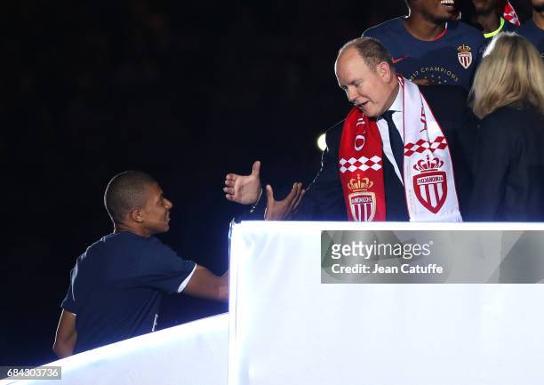 Prince Albert II of Monaco greets Kylian Mbappe of Monaco during the French Ligue 1 Championship title celebration following the French Ligue 1 match...