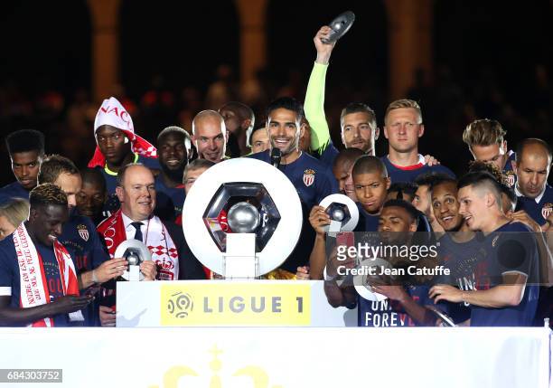 Captain of AS Monaco Radamel Falcao speaks before holding the trophy while Prince Albert II of Monaco looks on during the French League 1...