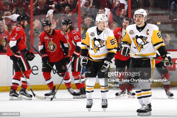 Sidney Crosby and Jake Guentzel of the Pittsburgh Penguins react after the fourth goal scored by Ottawa Senators during the first period in Game...