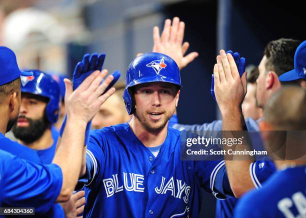 Justin Smoak of the Toronto Blue Jays is congratulated by teammates after hitting a two-run fourth inning home run against the Atlanta Braves at...