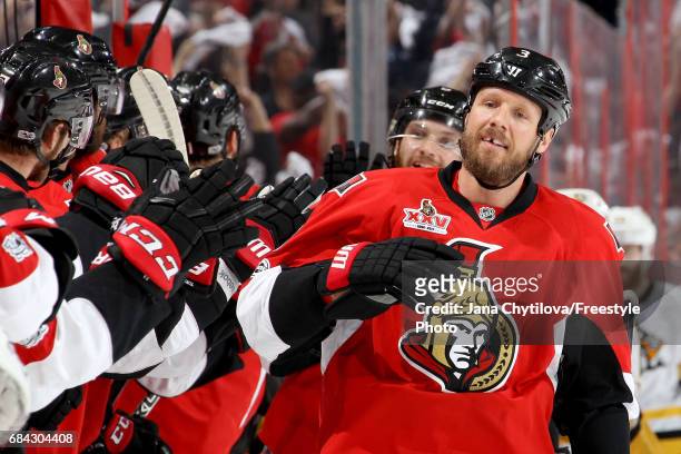 Marc Methot of the Ottawa Senators celebrates with his teammates after scoring a goal against Marc-Andre Fleury of the Pittsburgh Penguins during the...