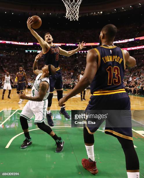 Kevin Love of the Cleveland Cavaliers rebounds the ball against Isaiah Thomas of the Boston Celtics as Tristan Thompson of the Cleveland Cavaliers...