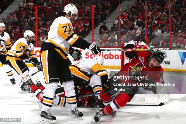 Evgeni Malkin of the Pittsburgh Penguins checks Jean-Gabriel Pageau of the Ottawa Senators to the ice during the second period in Game Three of the...