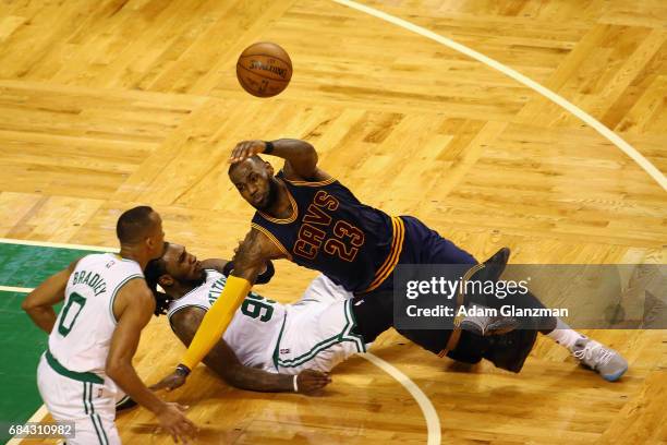 LeBron James of the Cleveland Cavaliers throws the ball as he gets tangled up with Jae Crowder of the Boston Celtics in the second half during Game...