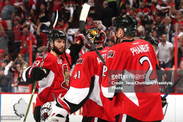 Craig Anderson of the Ottawa Senators celebrates with his teammates Derick Brassard and Dion Phaneuf after defeating the Pittsburgh Penguins with a...