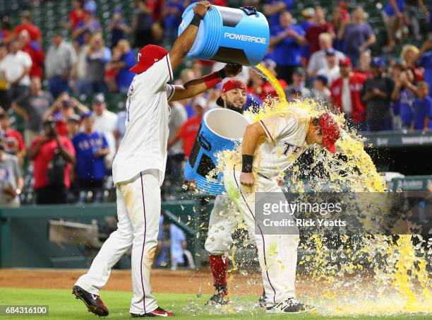 Elvis Andrus of the Texas Rangers and Rougned Odor celebrate Jared Hoying first major league home run with dumping the coolers on him at the end of...