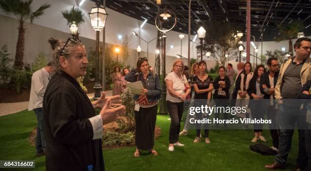 Cuban artist Carlos Garaicoa talks to visitors about his exhibition project "Yo nunca he sido surrealista hasta el da de hoy", that occupies nearly...