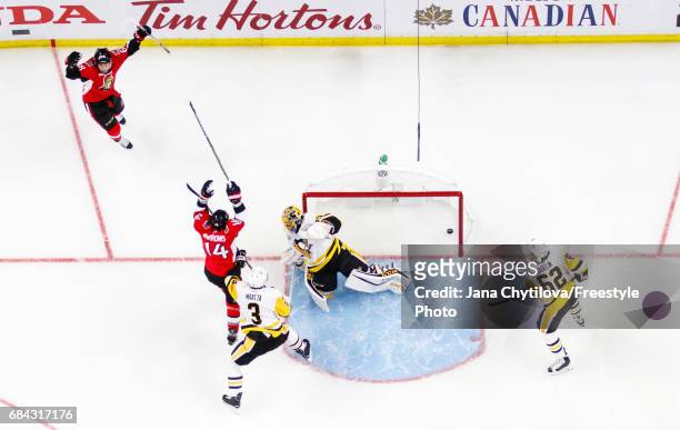Mike Hoffman of the Ottawa Senators celebrates his first period goal with teammate Alexandre Burrows as Marc-Andre Fleury, Olli Maatta and Carl...
