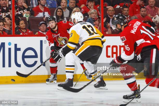 Chris Wideman of the Ottawa Senators passes the puck to Clarke MacArthur against Nick Bonino the Pittsburgh Penguins in Game Three of the Eastern...