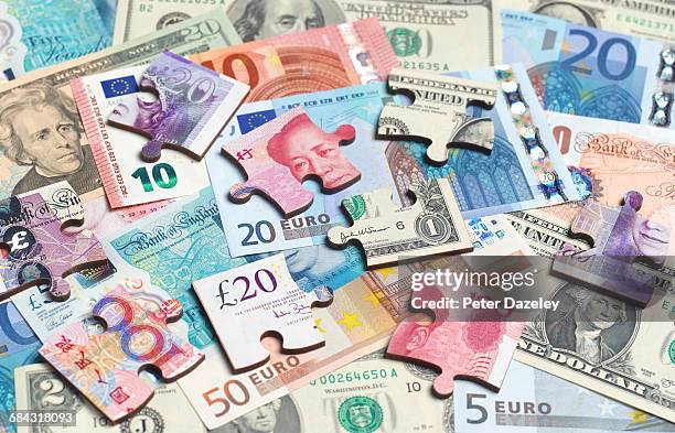 mix of currencies jigsaw pieces - global games london stock pictures, royalty-free photos & images