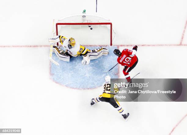 Derick Brassard of the Ottawa Senators scores a first period goal against Marc-Andre Fleury of the Pittsburgh Penguins as Mark Streit of the...