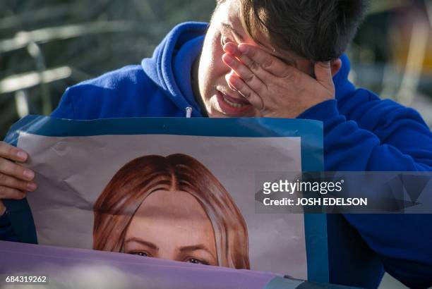 Meagan Melton cries while carrying a poster of Chelsea Manning in the Castro District of San Francisco, California on May 17 during a celebration for...