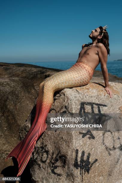 Davi de Oliveira Moreira, known as Sereio , poses in his mermaid tail costume at Arpoador Rock on Ipanema Beach in Rio de Janeiro, Brazil, on May 3,...