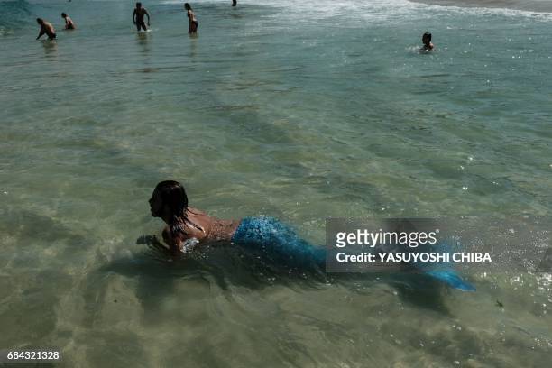 Davi de Oliveira Moreira, known as Sereio , wears a blue mermaid tail to swim at Ipanema Beach in Rio de Janeiro, Brazil, on May 3, 2017. The...