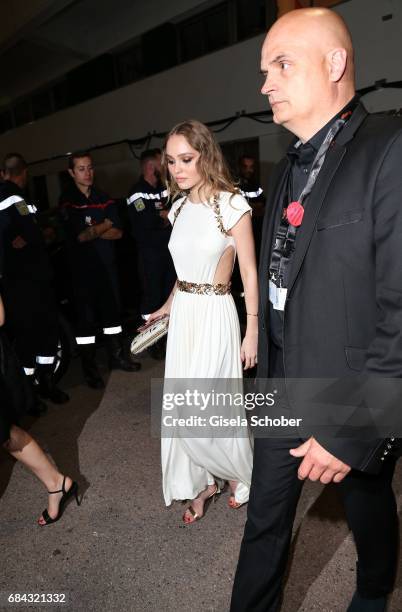 Lily-Rose Depp, daughter of Johnny Depp, leaves the "Ismael's Ghosts " screening and Opening Gala during the 70th annual Cannes Film Festival at...