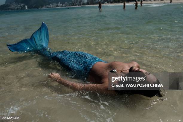 Davi de Oliveira Moreira, known as Sereio , wears a blue mermaid tail to swim at Ipanema Beach in Rio de Janeiro, Brazil, on May 3, 2017. The...