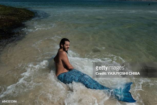 Davi de Oliveira Moreira, known as Sereio , wears a blue mermaid tail to swim at Ipanema Beach in Rio de Janeiro, Brazil, on May 3, 2017. The...