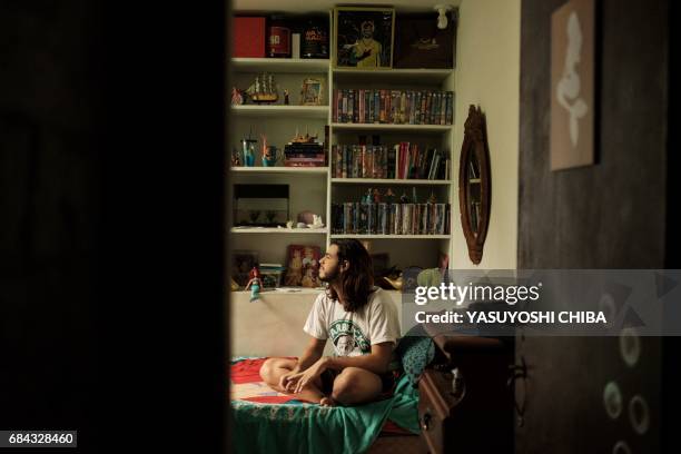 Davi de Oliveira Moreira, known as Sereio , sits on his bed at his home in Rio de Janeiro, Brazil, on May 3, 2017. The 22-year-old Brazilian is part...