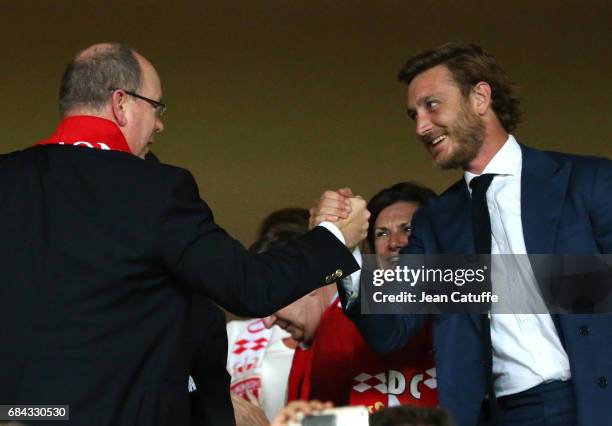 Prince Albert II of Monaco greets Pierre Casiraghi at final whistle to celebrate winning the French Ligue 1 Championship title following the match...