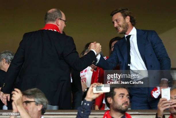 Prince Albert II of Monaco greets Pierre Casiraghi at final whistle to celebrate winning the French Ligue 1 Championship title following the match...