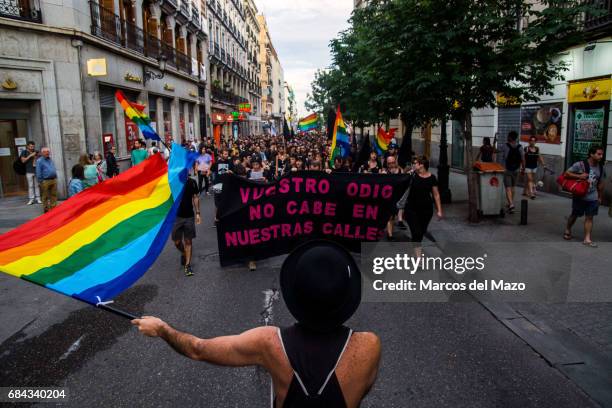Man waving the rainbow flag during a demonstration for the International Day against Homophobia, Transphobia and Biphobia.