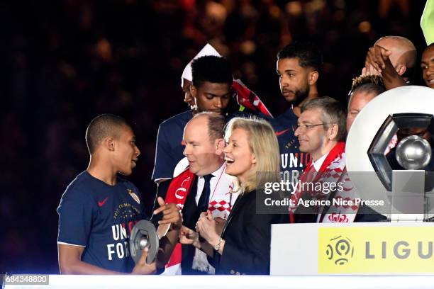 Kylian Mbappe of Monaco celebrates winning the Ligue 1 title with Prince Albert of Monaco and Nathalie Boy de la Tour president of LFP during the...