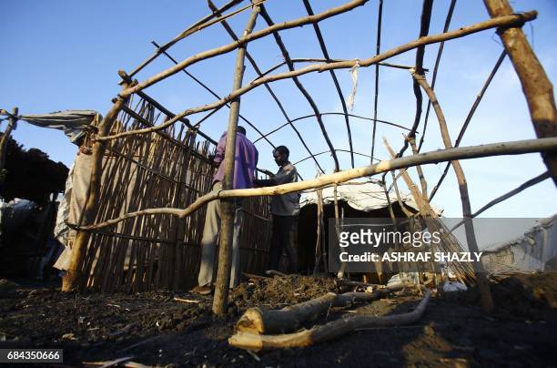 South Sudanese refugees build a hut at the UNHCR camp of al-Algaya in Sudan's White Nile state, south of Khartoum, on May 17, 2017. More than 95,000...