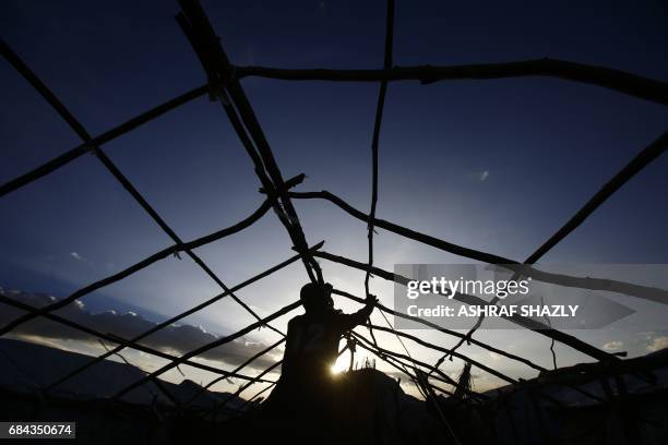 South Sudanese refugees build a hut at the UNHCR camp of al-Algaya in Sudan's White Nile state, south of Khartoum, on May 17, 2017. More than 95,000...