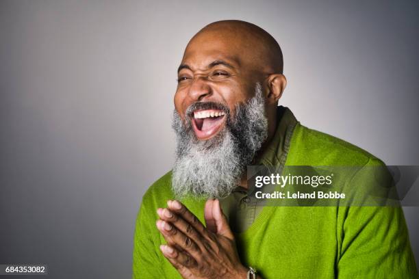 portrait of middle aged bald african american man with beard - mature men laughing stock pictures, royalty-free photos & images