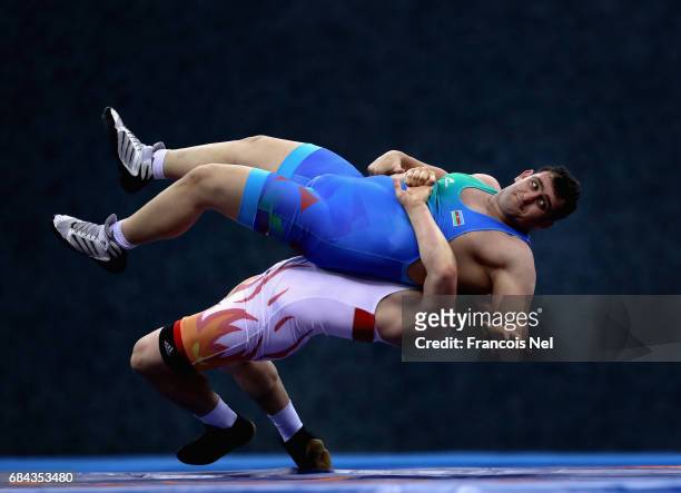Muminjon Abdullaev of Uzbekistan and Sabah Shariati of Azerbaijan competes in the Mens Greco Roman Wrestling 130 kg Semi Final during day six of Baku...