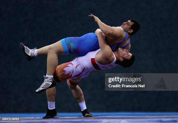 Muminjon Abdullaev of Uzbekistan and Sabah Shariati of Azerbaijan competes in the Mens Greco Roman Wrestling 130 kg Semi Final during day six of Baku...