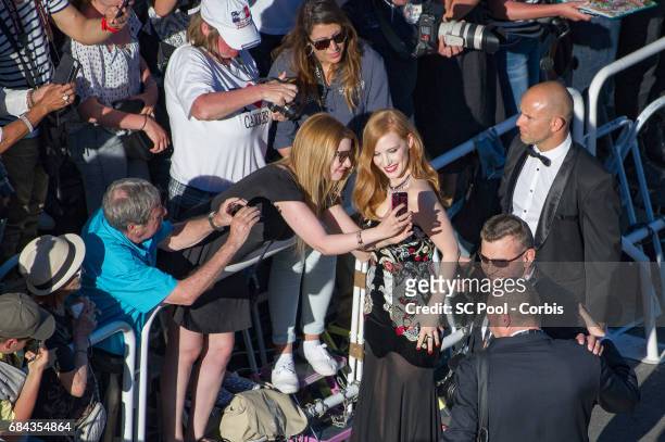 Jury member Jessica Chastain poses for selfies with fans as she attends the "Ismael's Ghosts " screening and Opening Gala during the 70th annual...