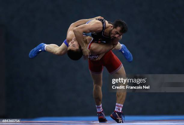 Abdulsamet Gunal of Turkey competes against Zhanat Kylybaev of Kazakstan in the Mens Greco Roman Wrestling 66 kg Quater Final during day seven of...