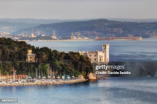 miramare castle with trieste in the background - triest stock-fotos und bilder