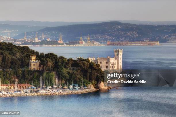 miramare castle with trieste in the background - kasteel miramare stockfoto's en -beelden