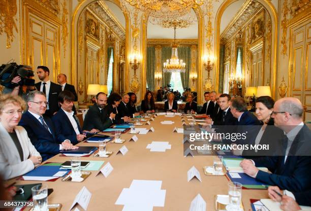 French President Emmanuel Macron faces his Prime Minister Edouard Philippe , during the first weekly cabinet meeting of the new government, at the...