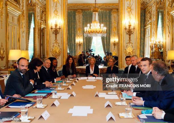 French President Emmanuel Macron faces his Prime Minister Edouard Philippe , during the first weekly cabinet meeting of the new government, at the...