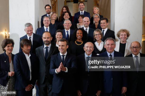 French President Emmanuel Macron and Prime Minister Edouard Philippe pose for a family photo after the first cabinet meeting at the Elysee Palace in...