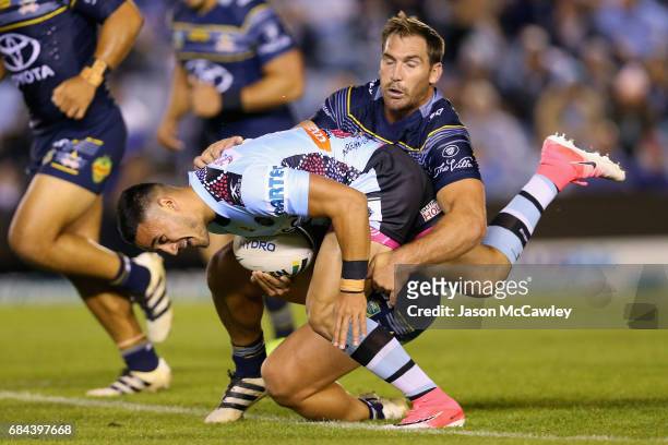 Valentine Holmes of the Sharks is tackled by Scott Bolton of the Cowboys during the round 11 NRL match between the Cronulla Sharks and the North...